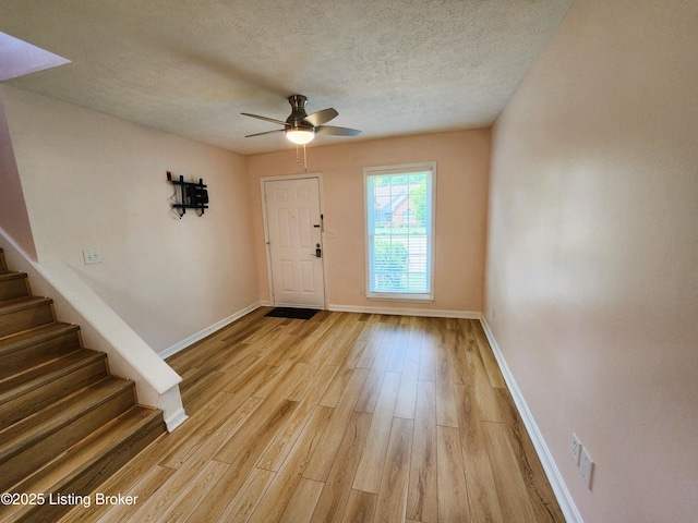 611 Malcolm Ave, Louisville, KY 40223 - foyer featuring stairs, light wood finished floors, a textured ceiling, and a ceiling fan