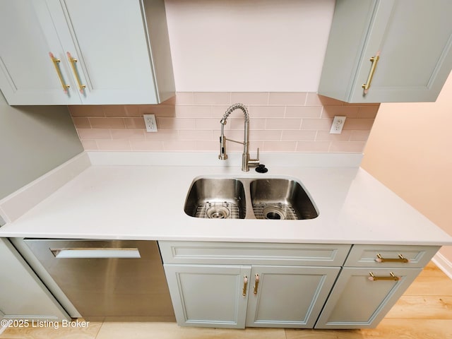 611 Malcolm Ave, Louisville, KY 40223 - kitchen featuring stainless steel dishwasher, light countertops, and tasteful backsplash
