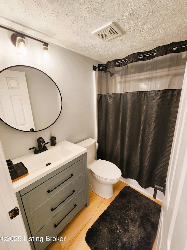 611 Malcolm Ave, Louisville, KY 40223 - full bath featuring vanity, wood finished floors, a textured ceiling, and a shower with curtain
