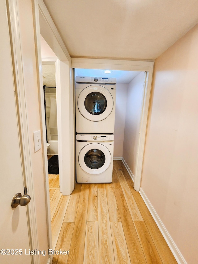 611 Malcolm Ave, Louisville, KY 40223 - laundry area with stacked washer / drying machine and light wood-style flooring