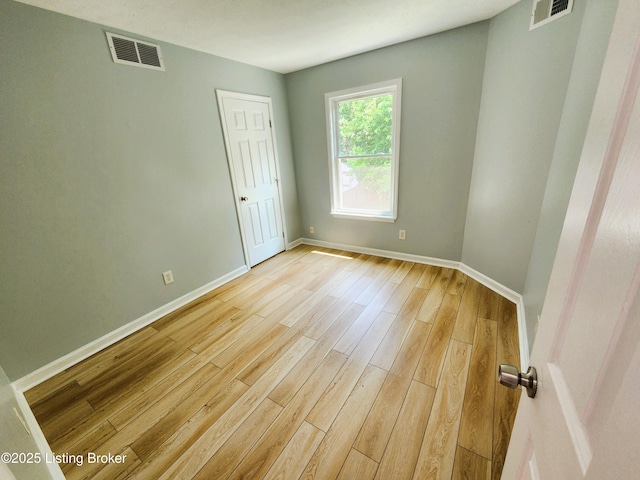 611 Malcolm Ave, Louisville, KY 40223 - spare room featuring baseboards and light wood-style flooring