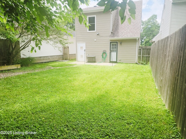 611 Malcolm Ave, Louisville, KY 40223 - rear view of property featuring a fenced backyard, a shingled roof, and a patio area