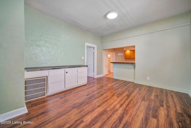 2060 S Preston St, Louisville, KY 40217 - unfurnished living room featuring wood finished floors and baseboards