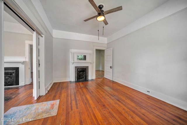 2060 S Preston St, Louisville, KY 40217 - unfurnished living room with a fireplace with flush hearth, baseboards, a ceiling fan, and wood finished floors