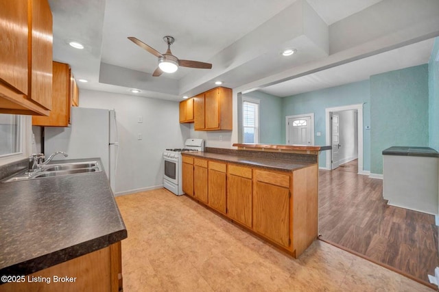 2060 S Preston St, Louisville, KY 40217 - kitchen with gas range gas stove, a sink, a peninsula, baseboards, and dark countertops