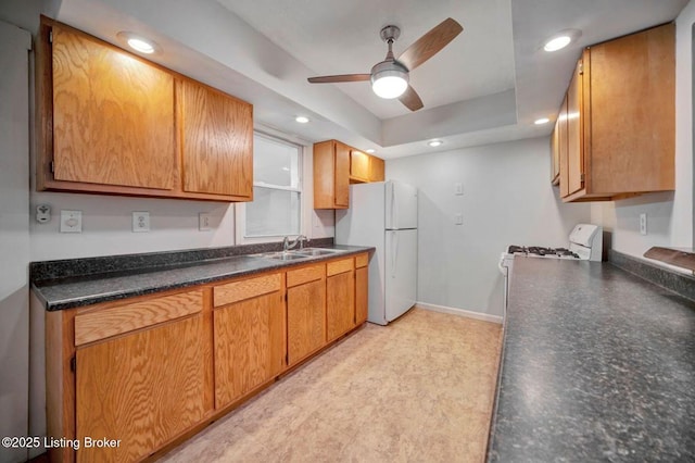 2060 S Preston St, Louisville, KY 40217 - kitchen with white appliances, a sink, ceiling fan, dark countertops, and baseboards