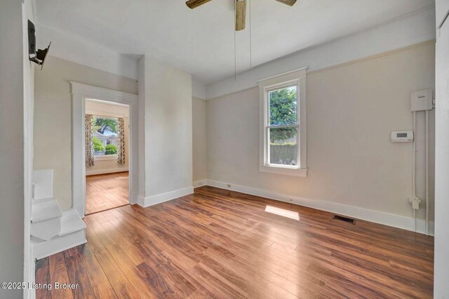 2060 S Preston St, Louisville, KY 40217 - empty room with plenty of natural light, hardwood / wood-style flooring, and baseboards