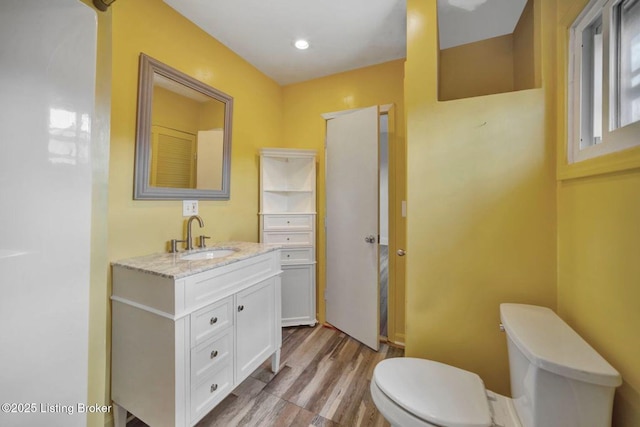 2060 S Preston St, Louisville, KY 40217 - bathroom with toilet, wood finished floors, and vanity
