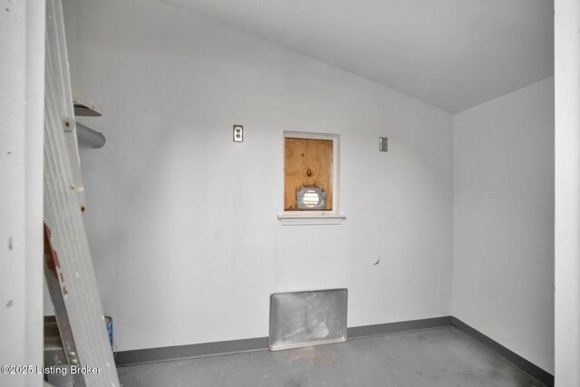 2060 S Preston St, Louisville, KY 40217 - spare room with baseboards, finished concrete flooring, and vaulted ceiling
