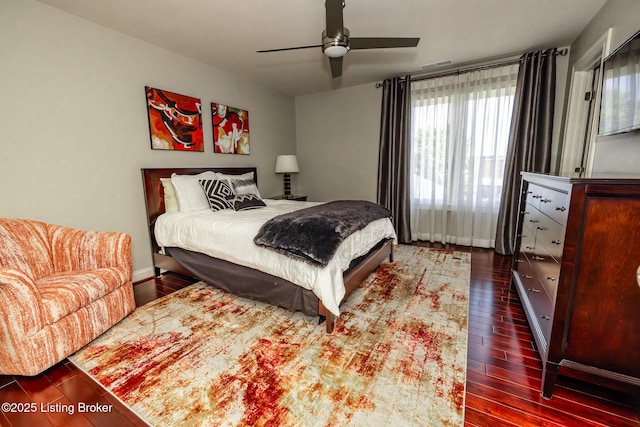 bedroom featuring a ceiling fan, dark wood-type flooring, and visible vents