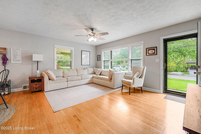 4203 Hewitt Ave, Louisville, KY 40220 - living area featuring wood finished floors, plenty of natural light, a ceiling fan, baseboards, and a textured ceiling