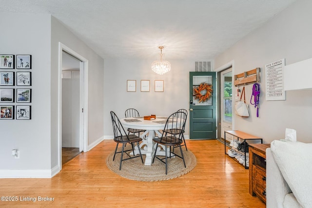 4203 Hewitt Ave, Louisville, KY 40220 - dining space featuring a chandelier, light wood-style flooring, and baseboards