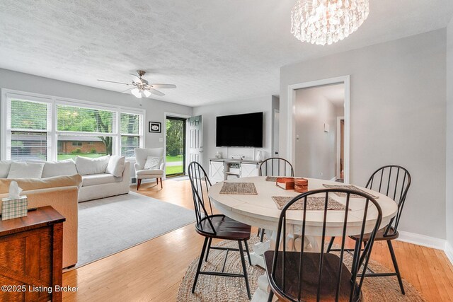 4203 Hewitt Ave, Louisville, KY 40220 - dining area with a ceiling fan, light wood finished floors, a chandelier, baseboards, and a textured ceiling