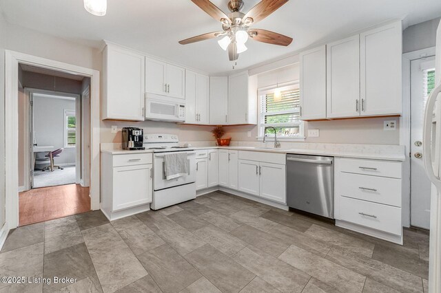 4203 Hewitt Ave, Louisville, KY 40220 - kitchen featuring white appliances, a sink, light countertops, and plenty of natural light