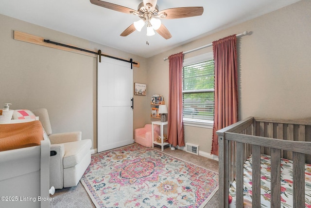 4203 Hewitt Ave, Louisville, KY 40220 - bedroom featuring a barn door, carpet flooring, baseboards, and ceiling fan