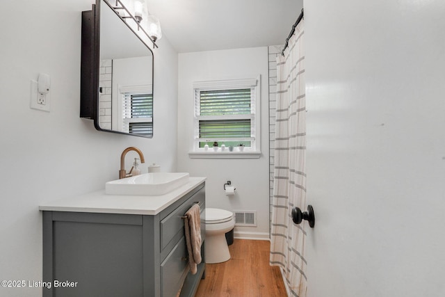 4203 Hewitt Ave, Louisville, KY 40220 - full bath featuring toilet, vanity, wood finished floors, and baseboards