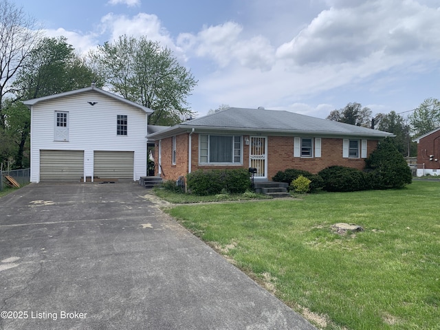 view of front of home featuring driveway, brick siding, an attached garage, and a front yard