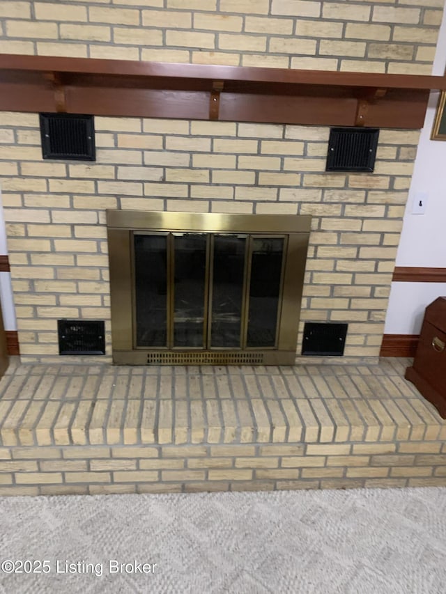 interior details featuring a brick fireplace and visible vents