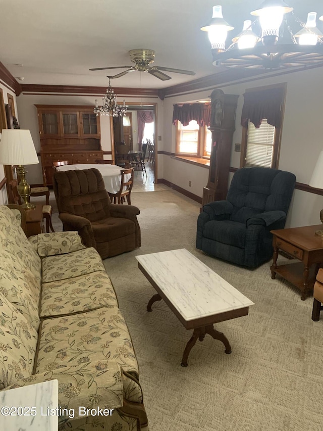 carpeted living area with ceiling fan with notable chandelier