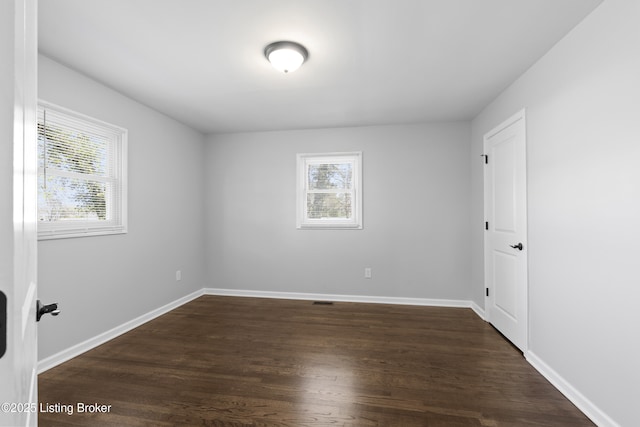 6487 New Glendale Rd, Glendale, KY 42740 - unfurnished room with baseboards, dark wood-style flooring, and plenty of natural light