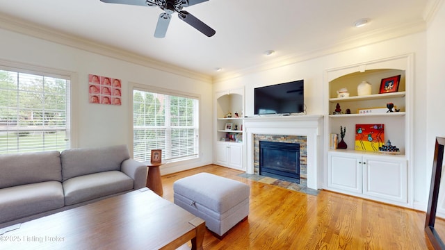 10513 Mountain Ash Ln, Prospect, KY 40059 - living room featuring a fireplace, a ceiling fan, light wood-style floors, ornamental molding, and built in features