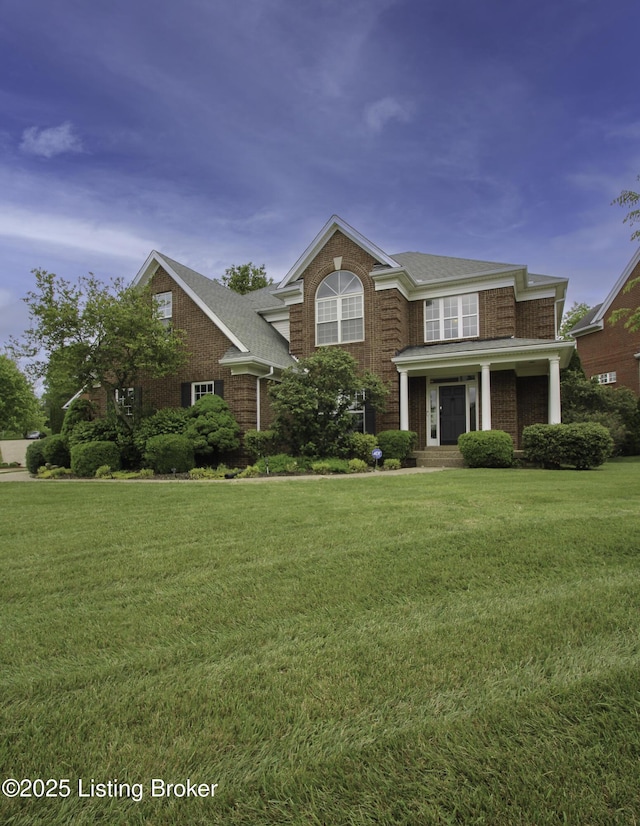 10513 Mountain Ash Ln, Prospect, KY 40059 - view of front of house featuring a front yard, roof with shingles, and covered porch