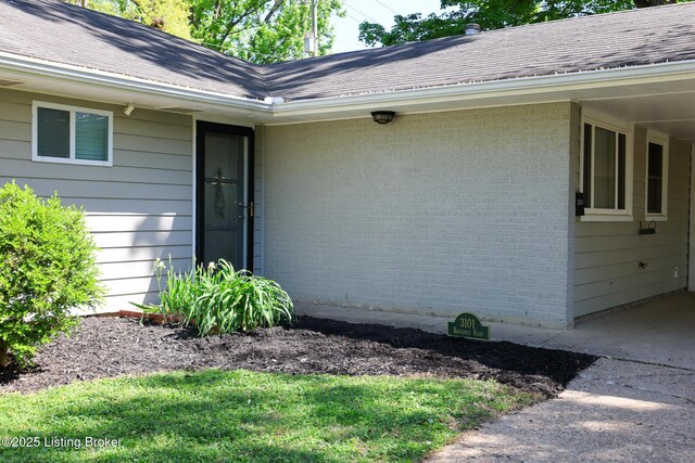 3101 Radiance Rd, Louisville, KY 40220 - property entrance with roof with shingles and brick siding