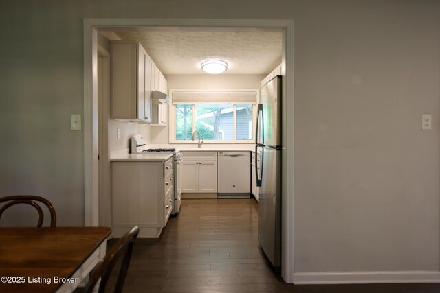 3101 Radiance Rd, Louisville, KY 40220 - kitchen with white appliances, white cabinets, light countertops, dark wood-type flooring, and a sink