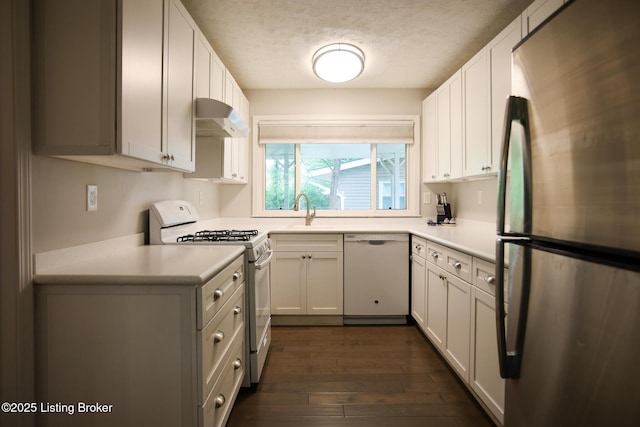 3101 Radiance Rd, Louisville, KY 40220 - kitchen with white appliances, under cabinet range hood, a sink, a textured ceiling, and dark wood finished floors