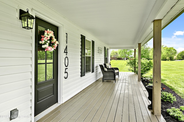 deck with covered porch and a lawn