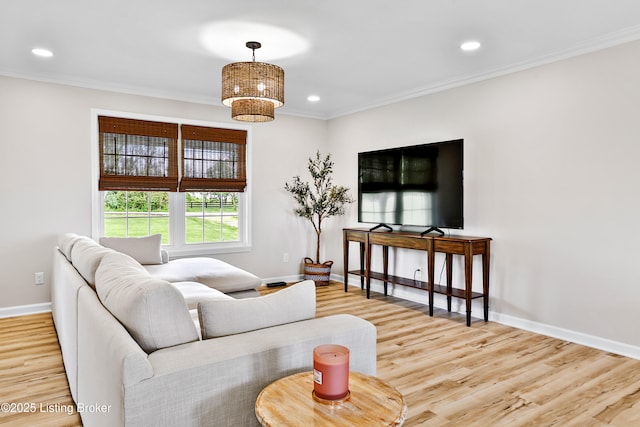 living area with crown molding, recessed lighting, baseboards, and wood finished floors