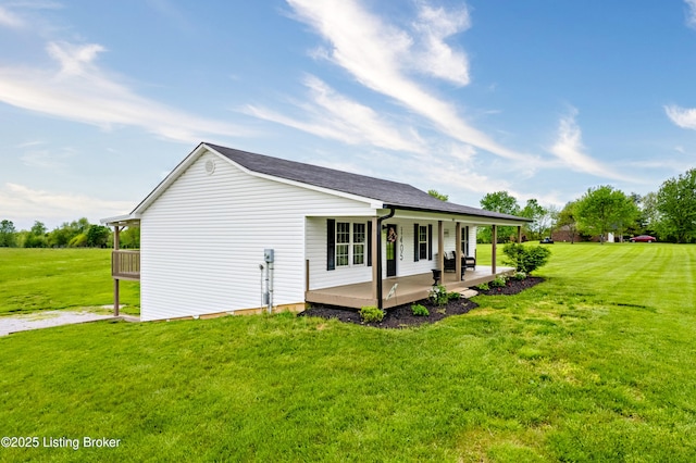 back of house featuring covered porch and a lawn