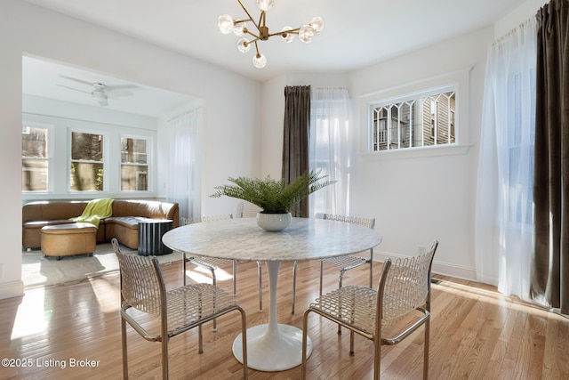 1245 S 7th St, Louisville, KY 40203 - dining room with light wood finished floors, a chandelier, and baseboards