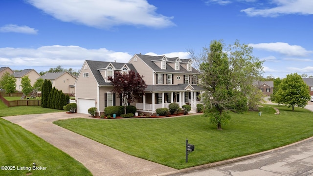 view of front of house with a garage, fence, concrete driveway, a front yard, and a porch