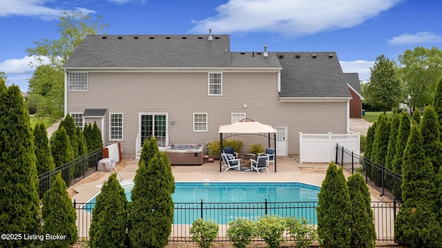 view of swimming pool featuring a patio area, a hot tub, a fenced in pool, and a fenced backyard