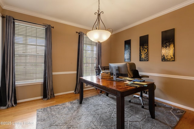 office area with ornamental molding, light wood-style floors, and baseboards