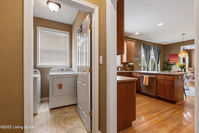 clothes washing area with laundry area, washer and clothes dryer, and recessed lighting