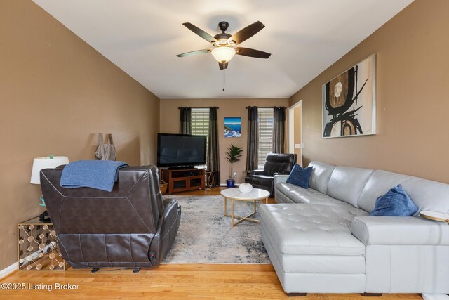 living room featuring a ceiling fan and wood finished floors