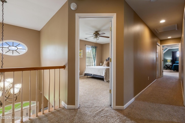 hallway featuring carpet and baseboards