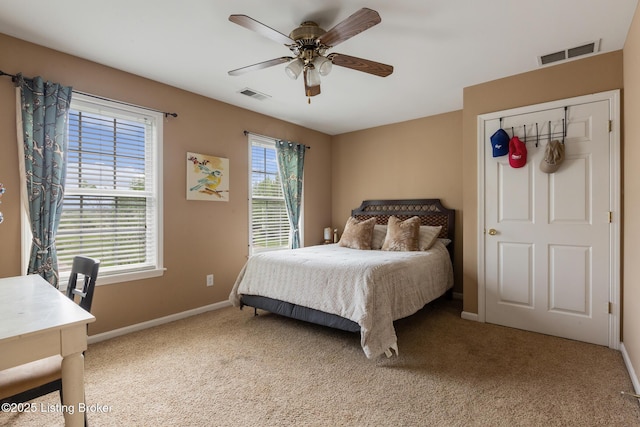 bedroom featuring carpet flooring, visible vents, baseboards, and ceiling fan