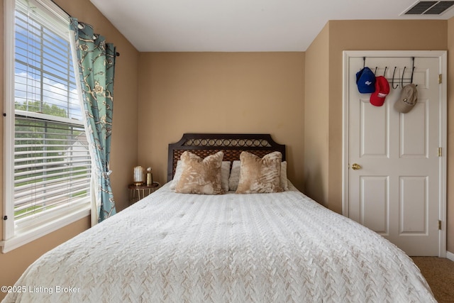 carpeted bedroom with visible vents