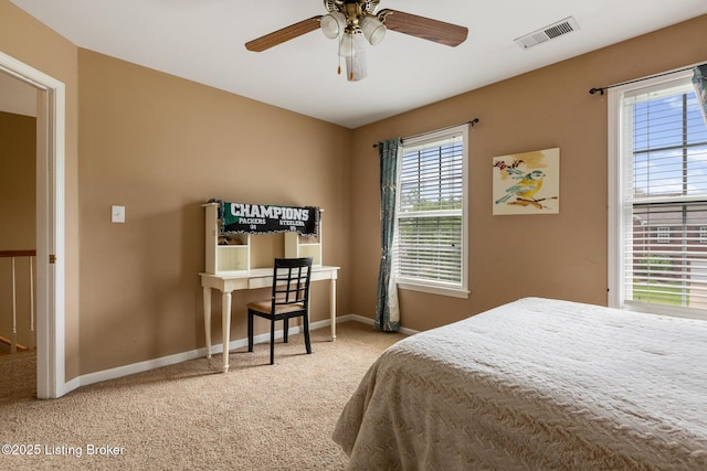 carpeted bedroom featuring visible vents, baseboards, and a ceiling fan