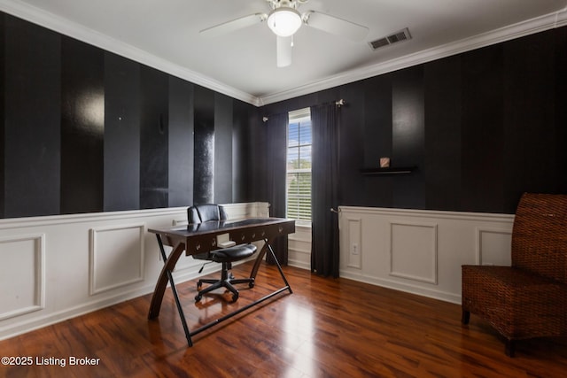 office area with wood finished floors, crown molding, visible vents, a decorative wall, and ceiling fan