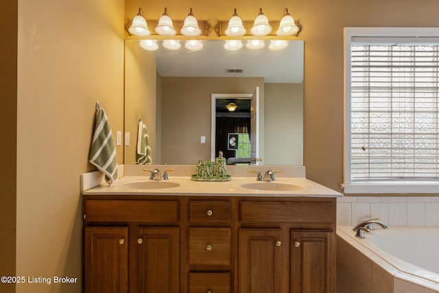 bathroom with a wealth of natural light, visible vents, a sink, and double vanity