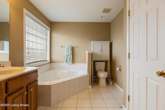 full bathroom with toilet, a tub with jets, tile patterned floors, visible vents, and vanity