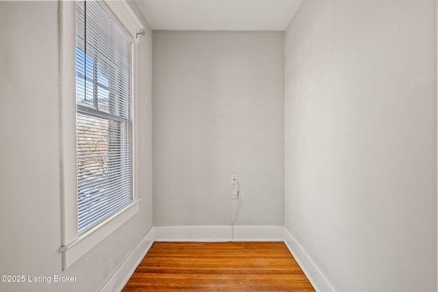 unfurnished room featuring wood finished floors and baseboards