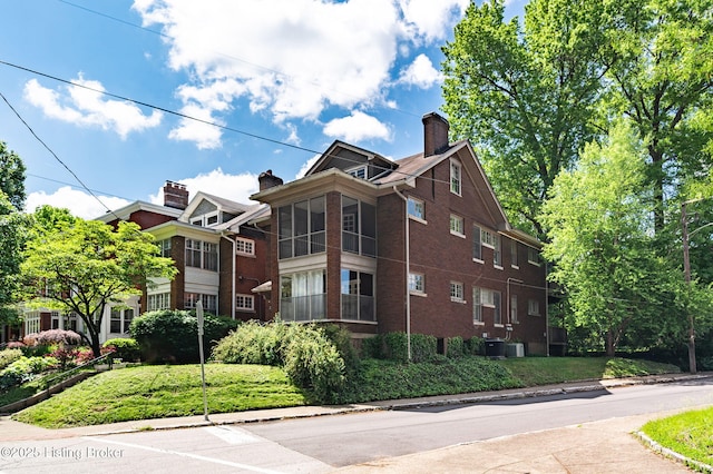 view of home's exterior featuring brick siding and a chimney