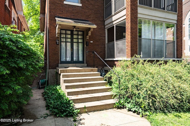 entrance to property with brick siding