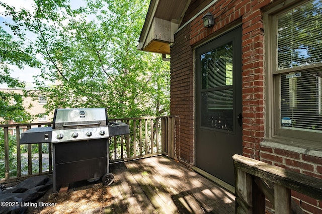 wooden deck featuring a grill