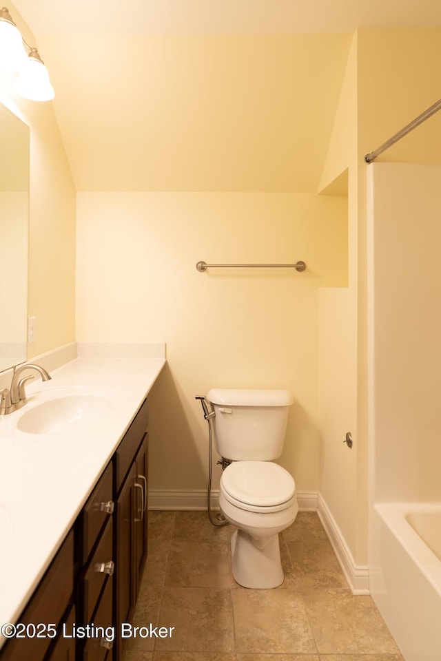 full bath with toilet, vanity, and baseboards
